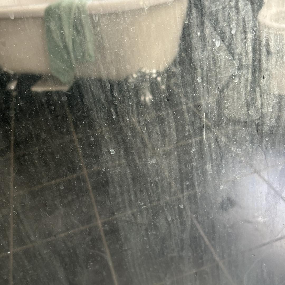 close up of dirty unclean shower glass window before cleaning